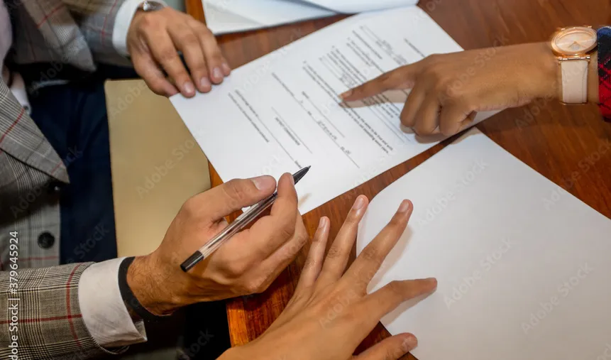 Business people signing legal documents